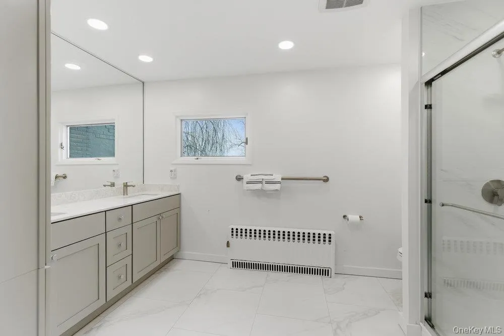 Primary bathroom with double vanity, quartz countertops, ceramic tile shower Primary bathroom with double vanity, quartz countertops, ceramic tile shower