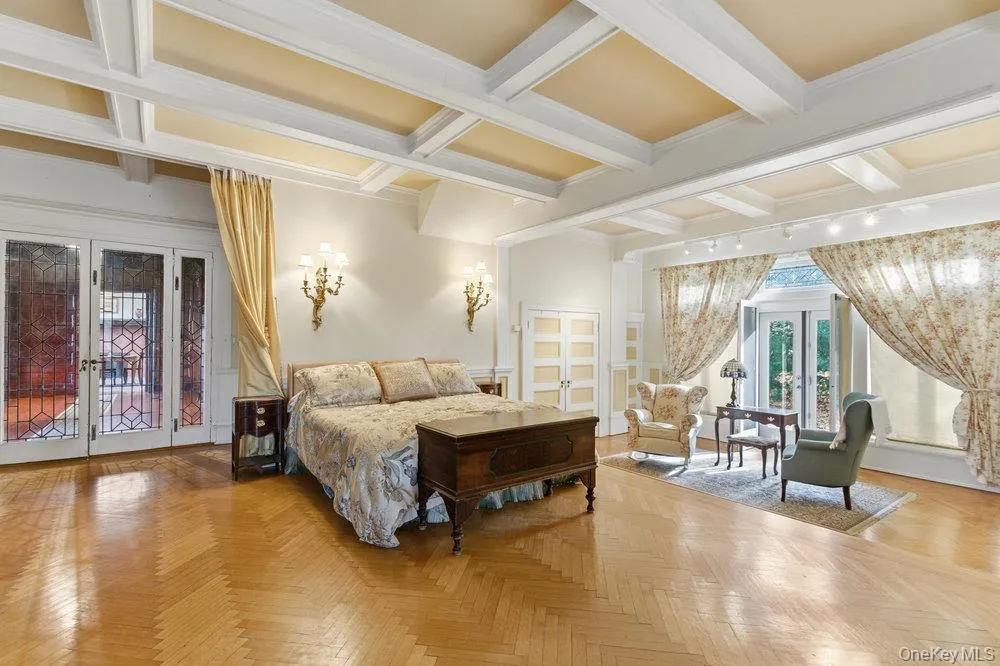 Bedroom with french doors, beamed coffered ceiling, sitting area, and ornamental molding, spectacular herringbone oak floors Bedroom with french doors, beamed coffered ceiling, sitting area, and ornamental molding, spectacular herringbone oak floors