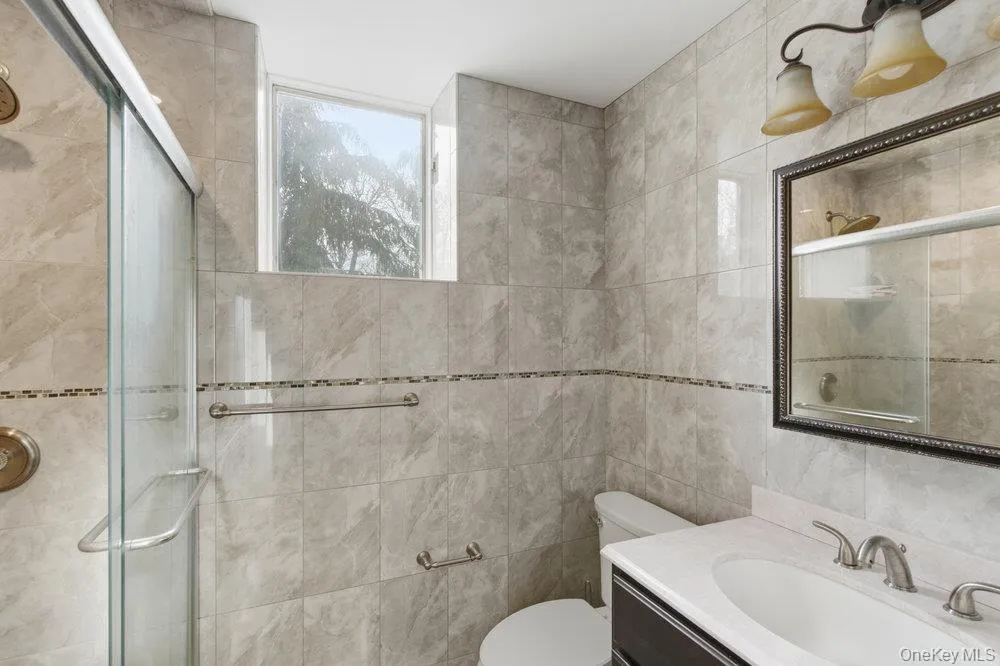 Full bath with vanity and a stall shower Full bath with vanity and a stall shower