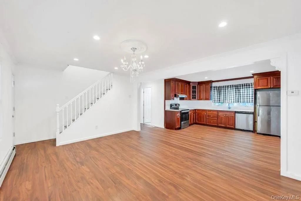 Kitchen featuring appliances with stainless steel finishes, light countertops, recessed lighting, pendant lighting, and glass insert cabinets Kitchen featuring appliances with stainless steel finishes, light countertops, recessed lighting, pendant lighting, and glass insert cabinets