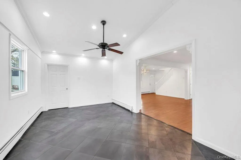 Unfurnished room featuring a baseboard heating unit, ornamental molding, ceiling fan, vaulted ceiling, and recessed lighting Unfurnished room featuring a baseboard heating unit, ornamental molding, ceiling fan, vaulted ceiling, and recessed lighting