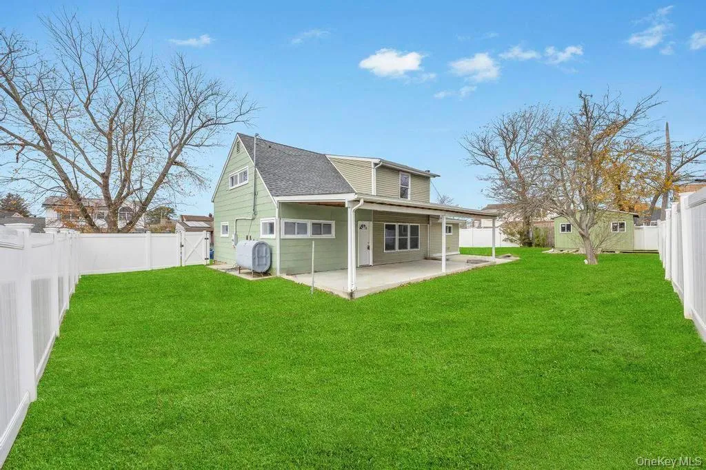 Rear view of property featuring a fenced backyard, heating fuel, and a patio Rear view of property featuring a fenced backyard, heating fuel, and a patio