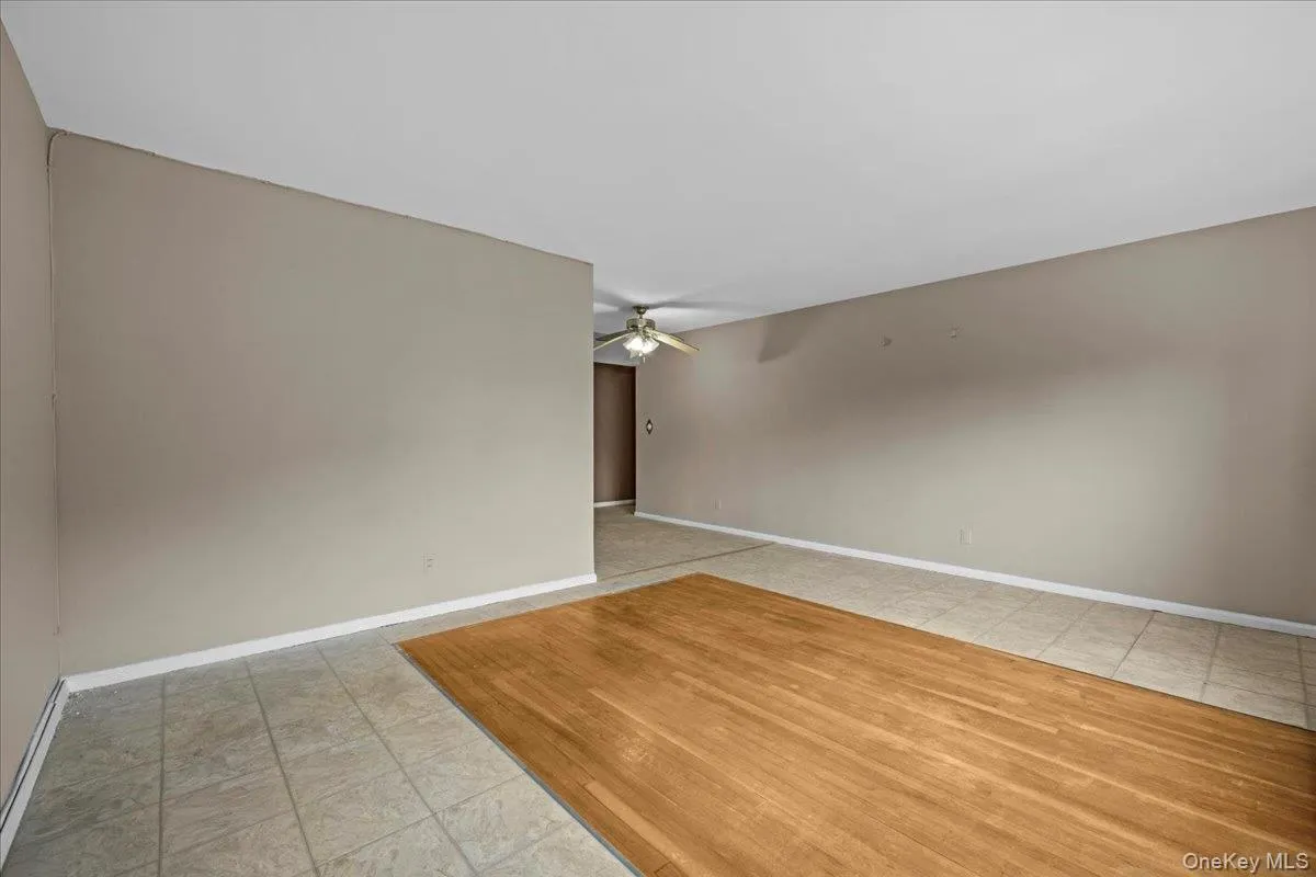Unfurnished room with light tile patterned flooring and ceiling fan Unfurnished room with light tile patterned flooring and ceiling fan