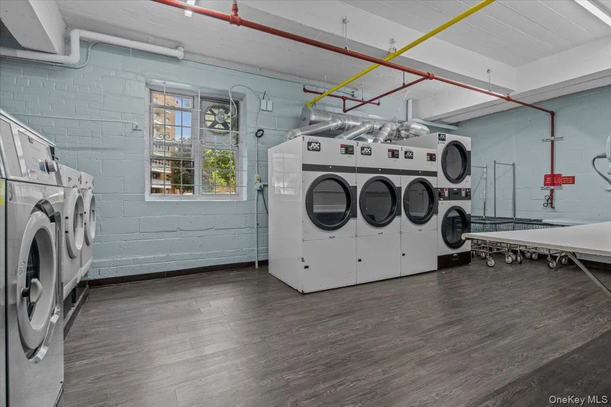 Community laundry room featuring washer and clothes dryer Community laundry room featuring washer and clothes dryer