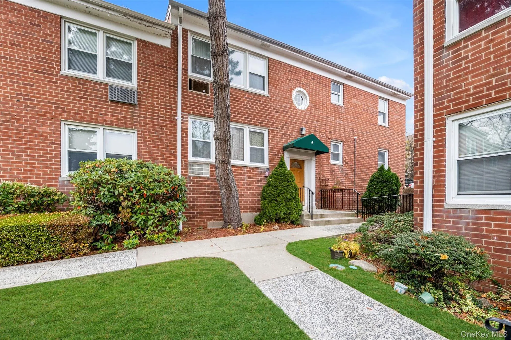 View of front facade with brick siding and a front lawn View of front facade with brick siding and a front lawn