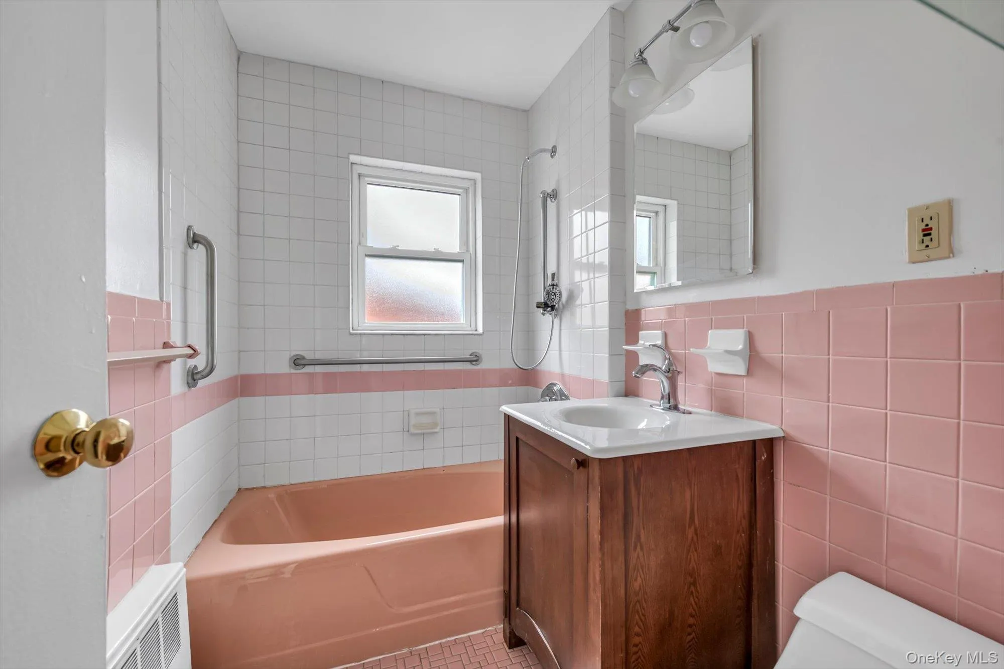 Bathroom with washtub / shower combination, vanity, and tile walls Bathroom with washtub / shower combination, vanity, and tile walls