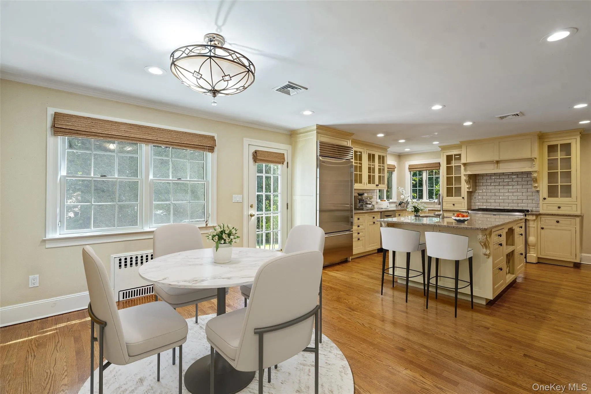 Dining space featuring radiator heating unit, light wood-style flooring, recessed lighting, and crown molding Dining space featuring radiator heating unit, light wood-style flooring, recessed lighting, and crown molding