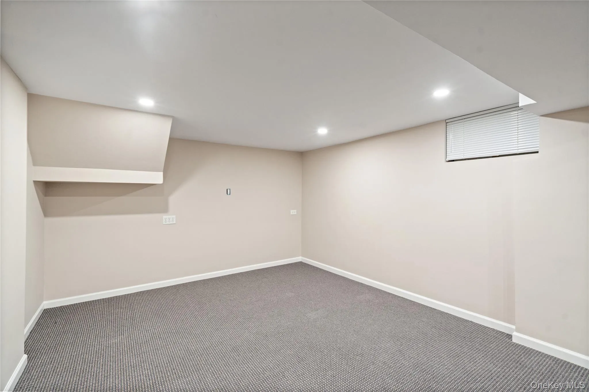 Finished basement with carpet floors and recessed lighting Finished basement with carpet floors and recessed lighting