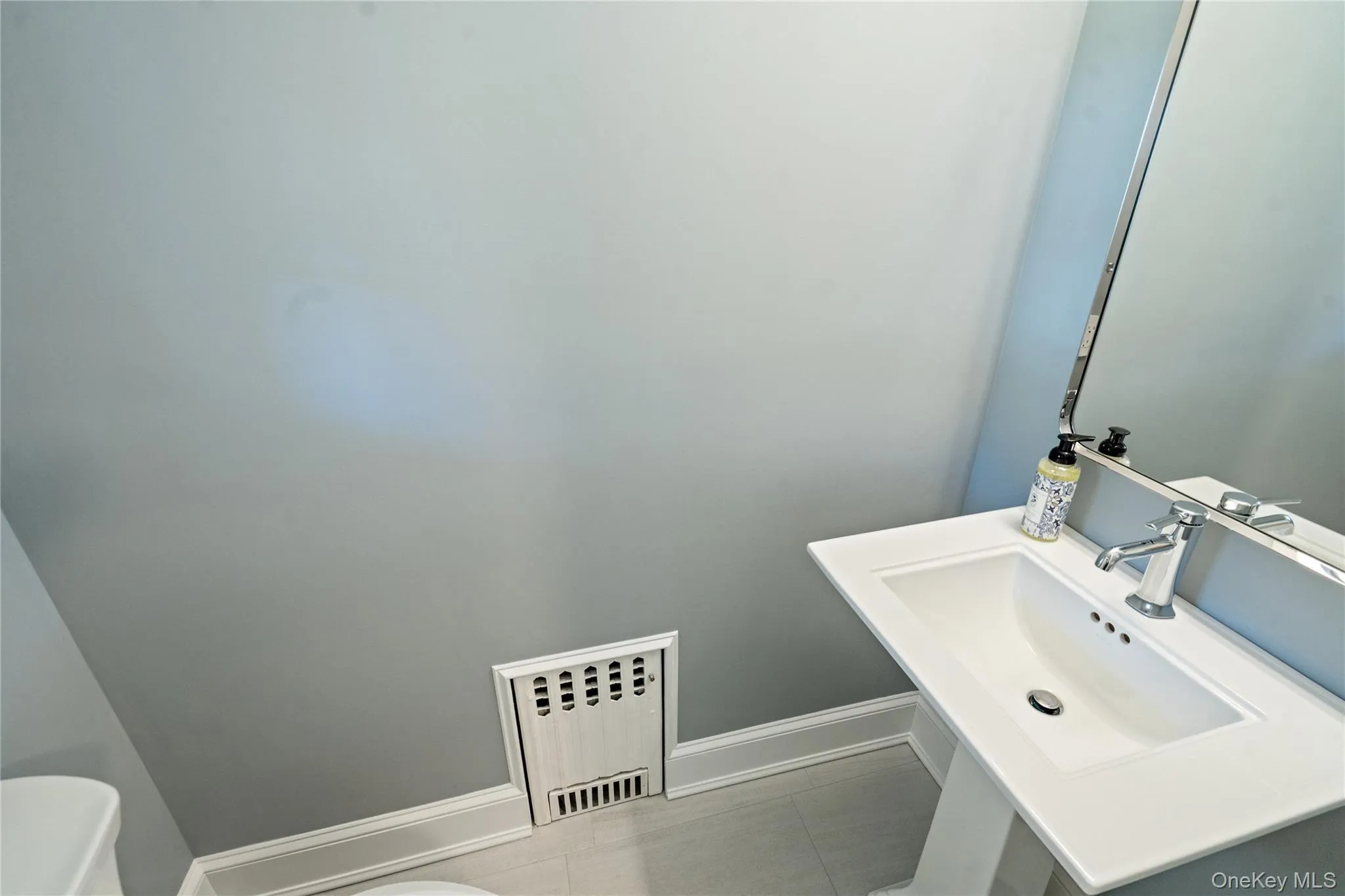 Bathroom with baseboards and radiator Bathroom with baseboards and radiator