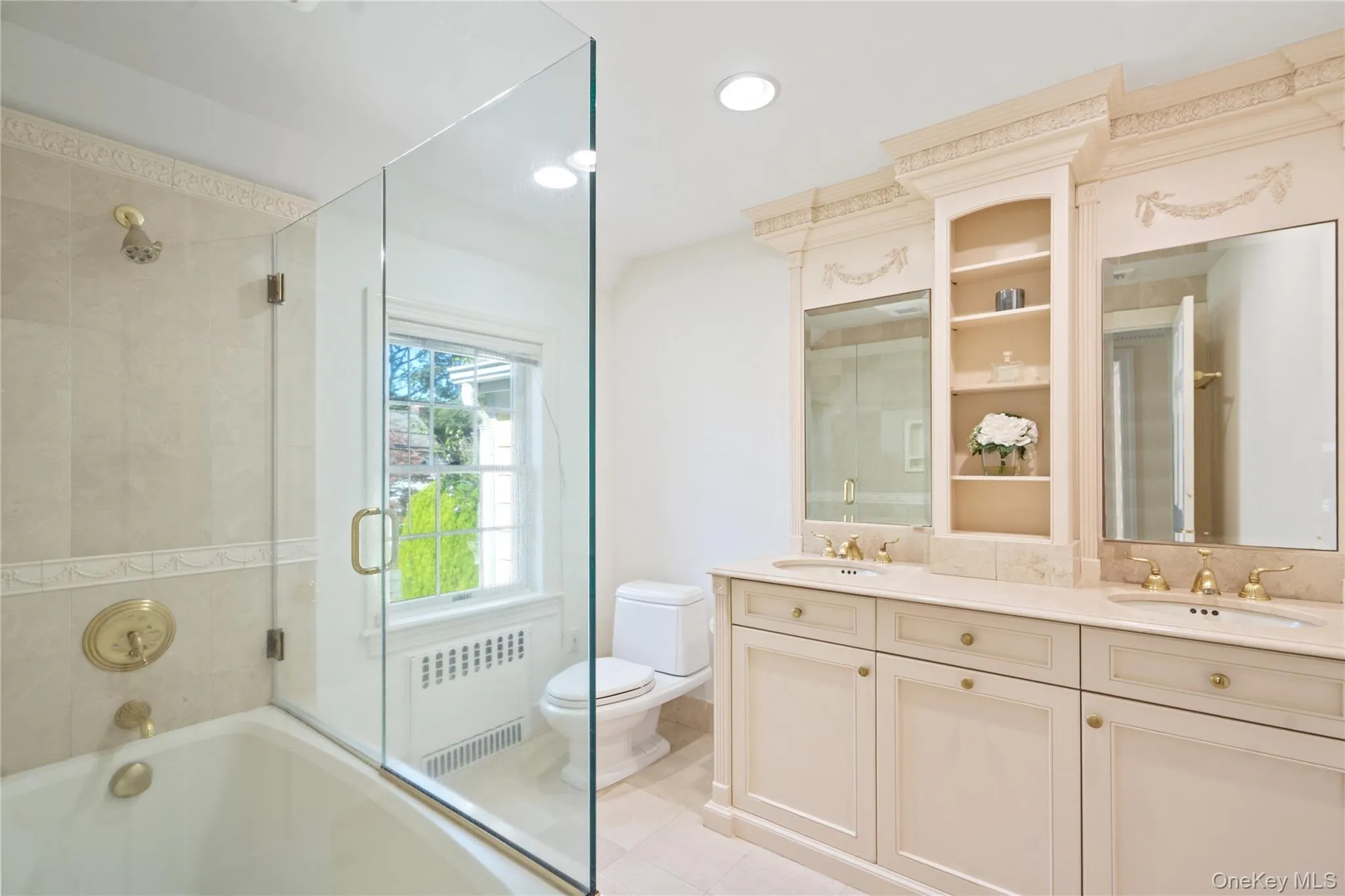 Full bathroom with radiator heating unit, double vanity, and recessed lighting Full bathroom with radiator heating unit, double vanity, and recessed lighting