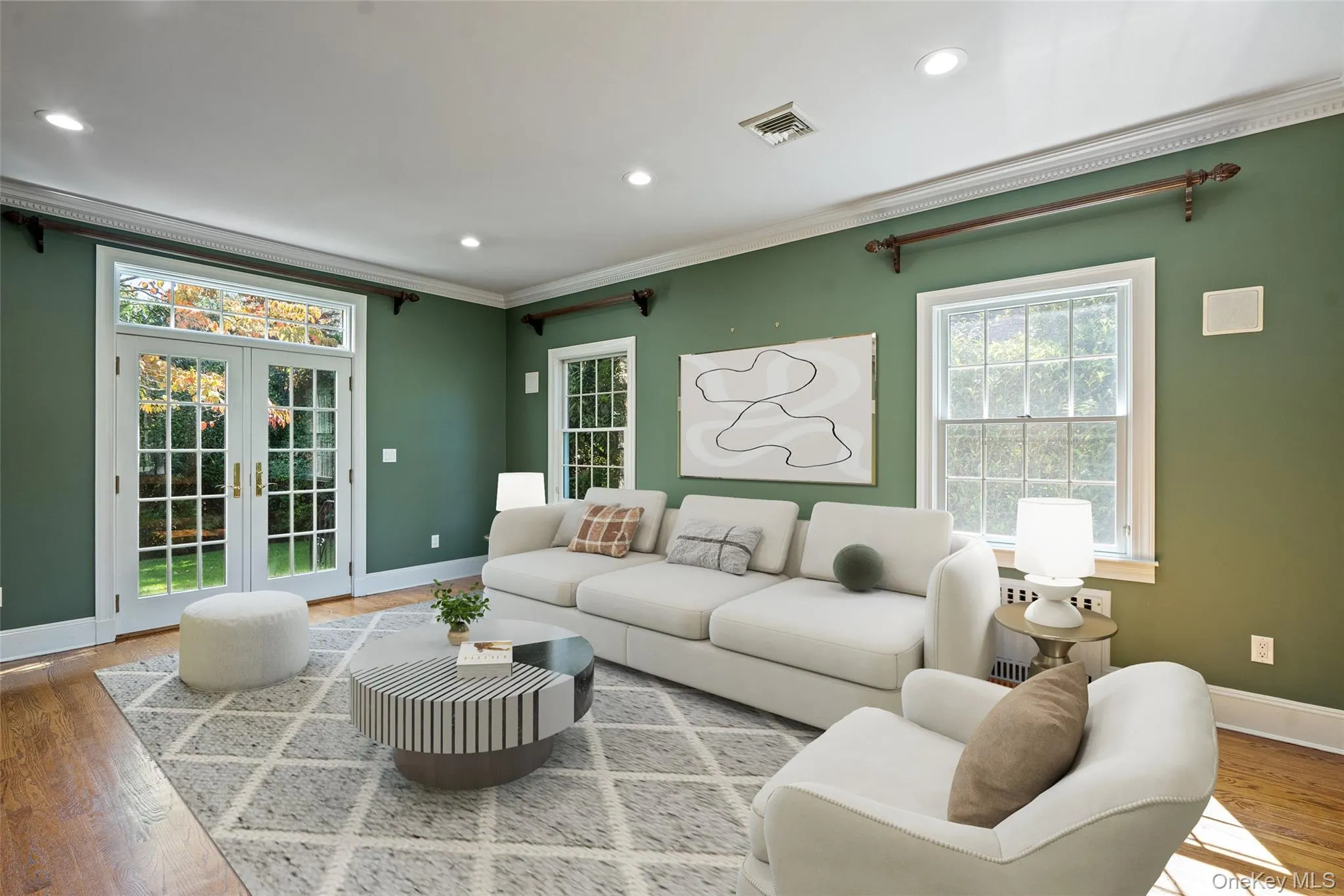 Living area with french doors, wood finished floors, recessed lighting, and ornamental molding Living area with french doors, wood finished floors, recessed lighting, and ornamental molding
