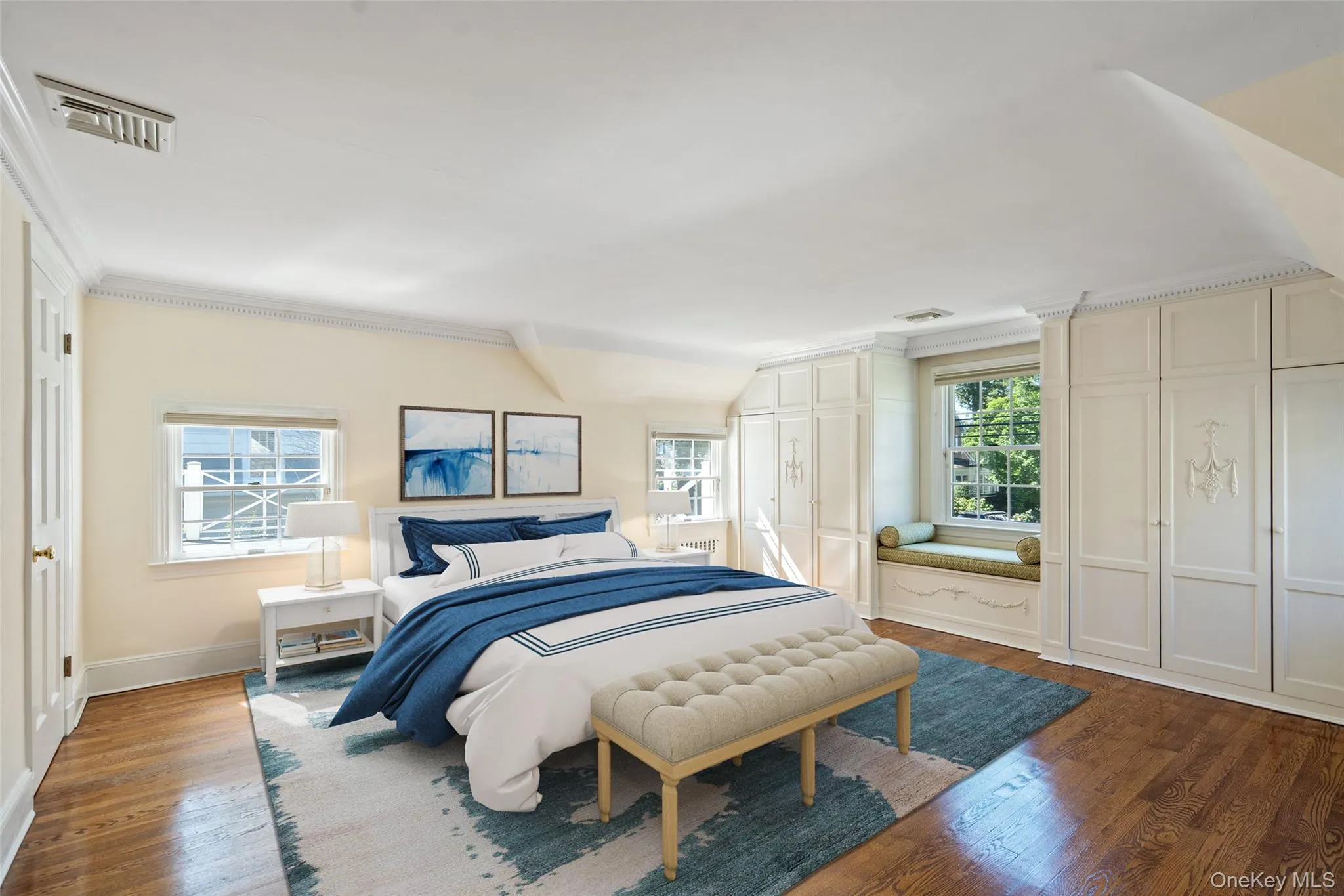 Bedroom with crown molding and wood finished floors Bedroom with crown molding and wood finished floors