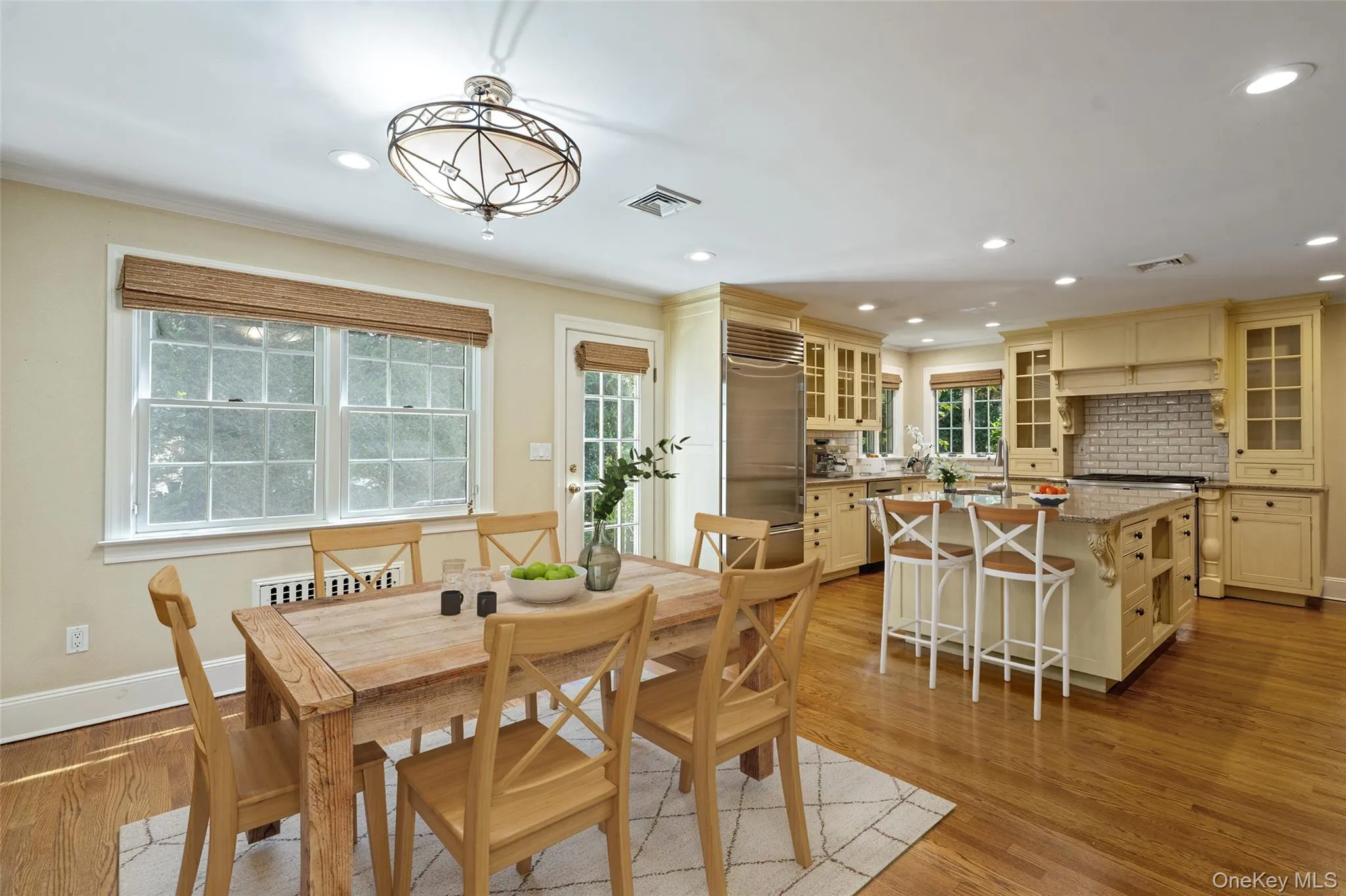 Dining area featuring light wood-type flooring, crown molding, and recessed lighting Dining area featuring light wood-type flooring, crown molding, and recessed lighting