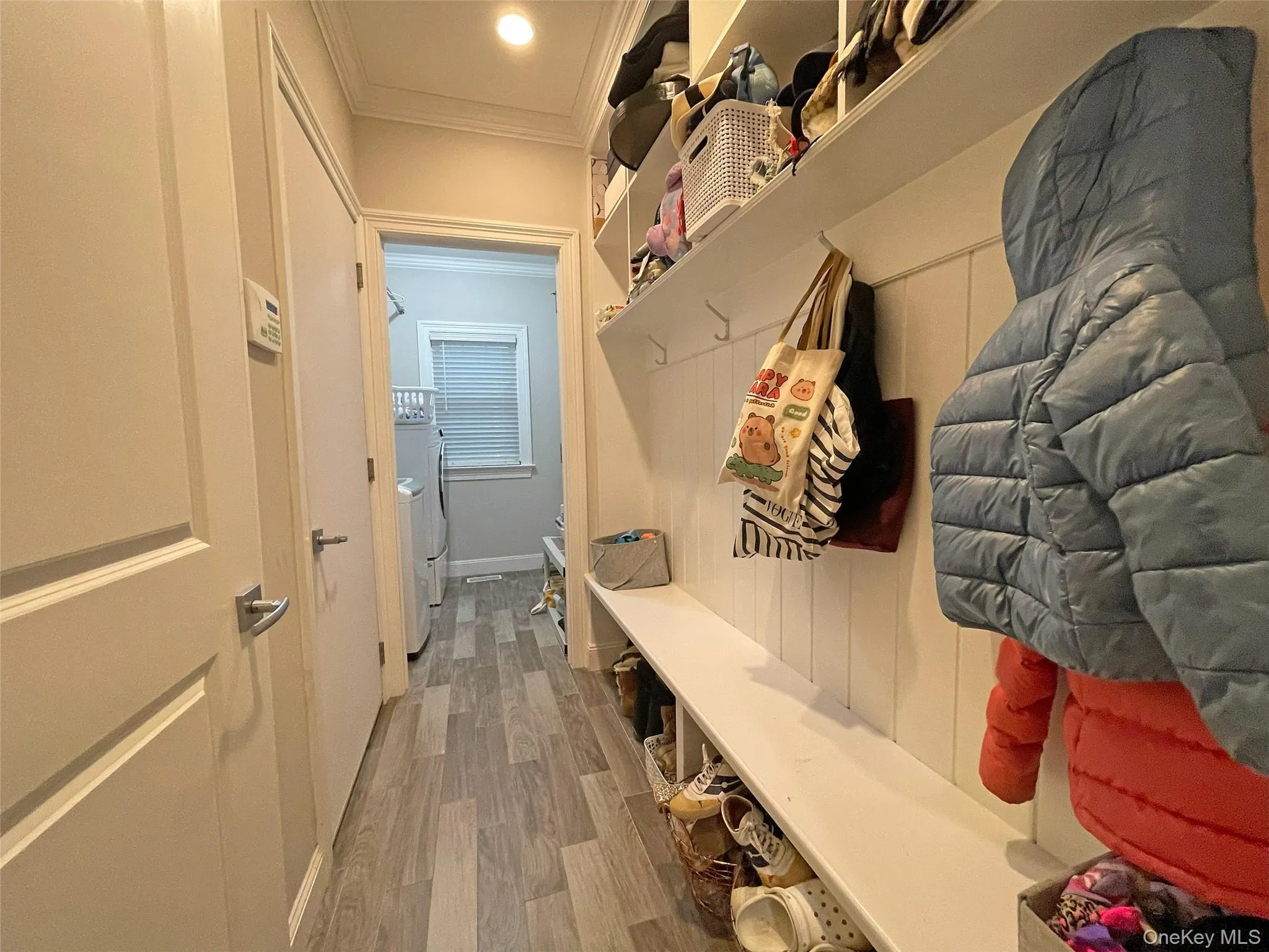 Mudroom with light wood finished floors and crown molding Mudroom with light wood finished floors and crown molding