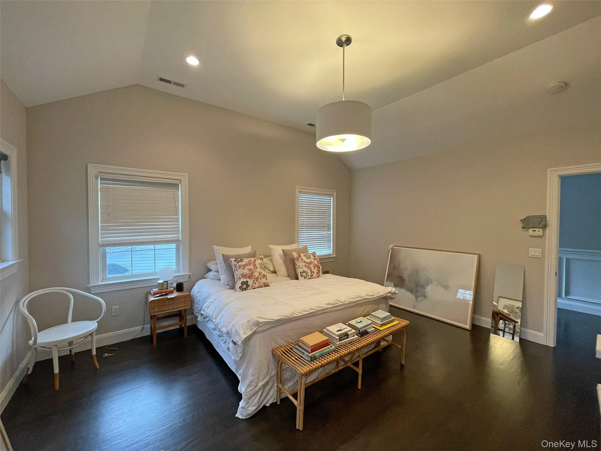 Bedroom with lofted ceiling, dark wood-type flooring, recessed lighting, and multiple windows Bedroom with lofted ceiling, dark wood-type flooring, recessed lighting, and multiple windows