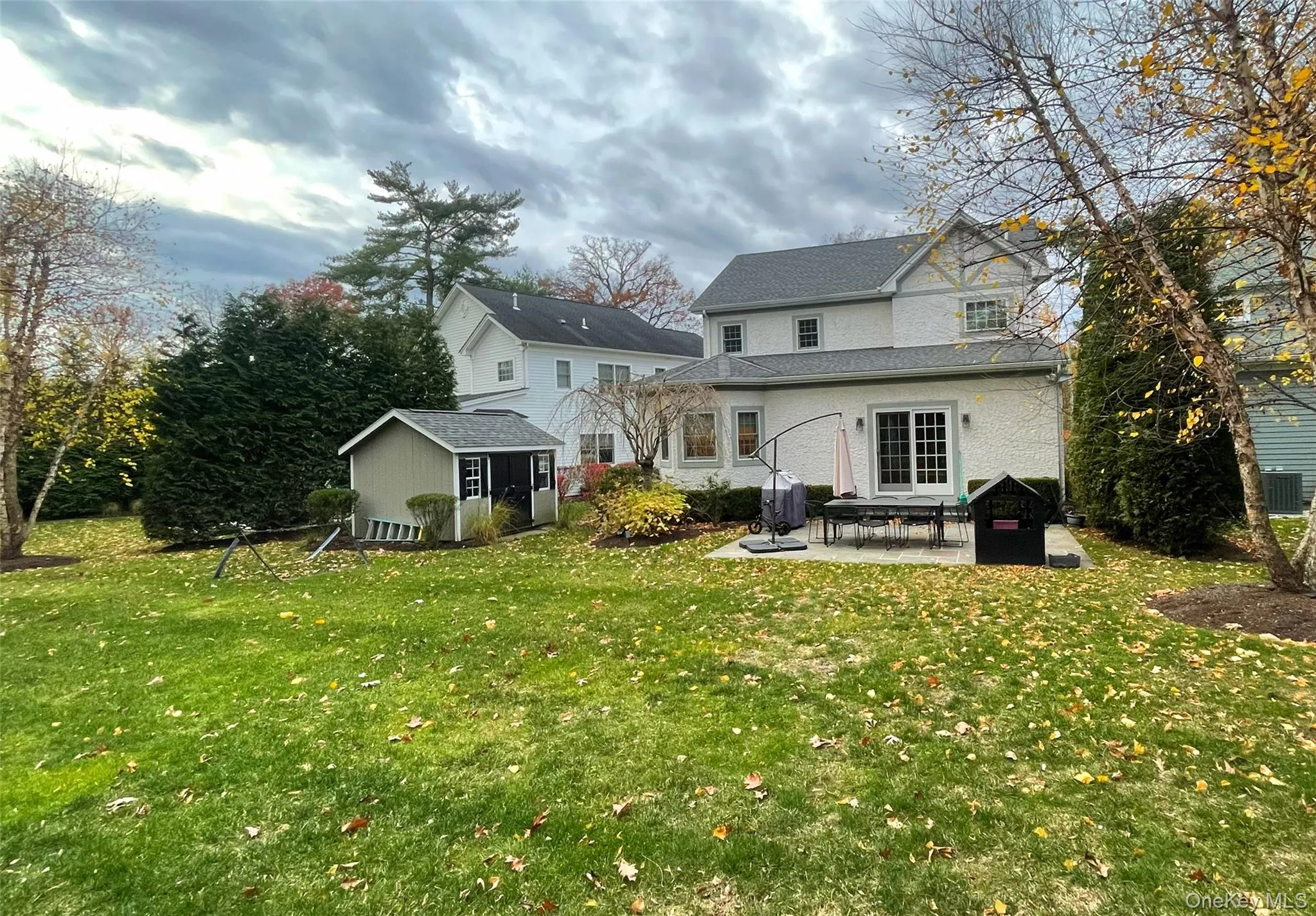 Back of property with a patio area, a storage shed, and a yard Back of property with a patio area, a storage shed, and a yard