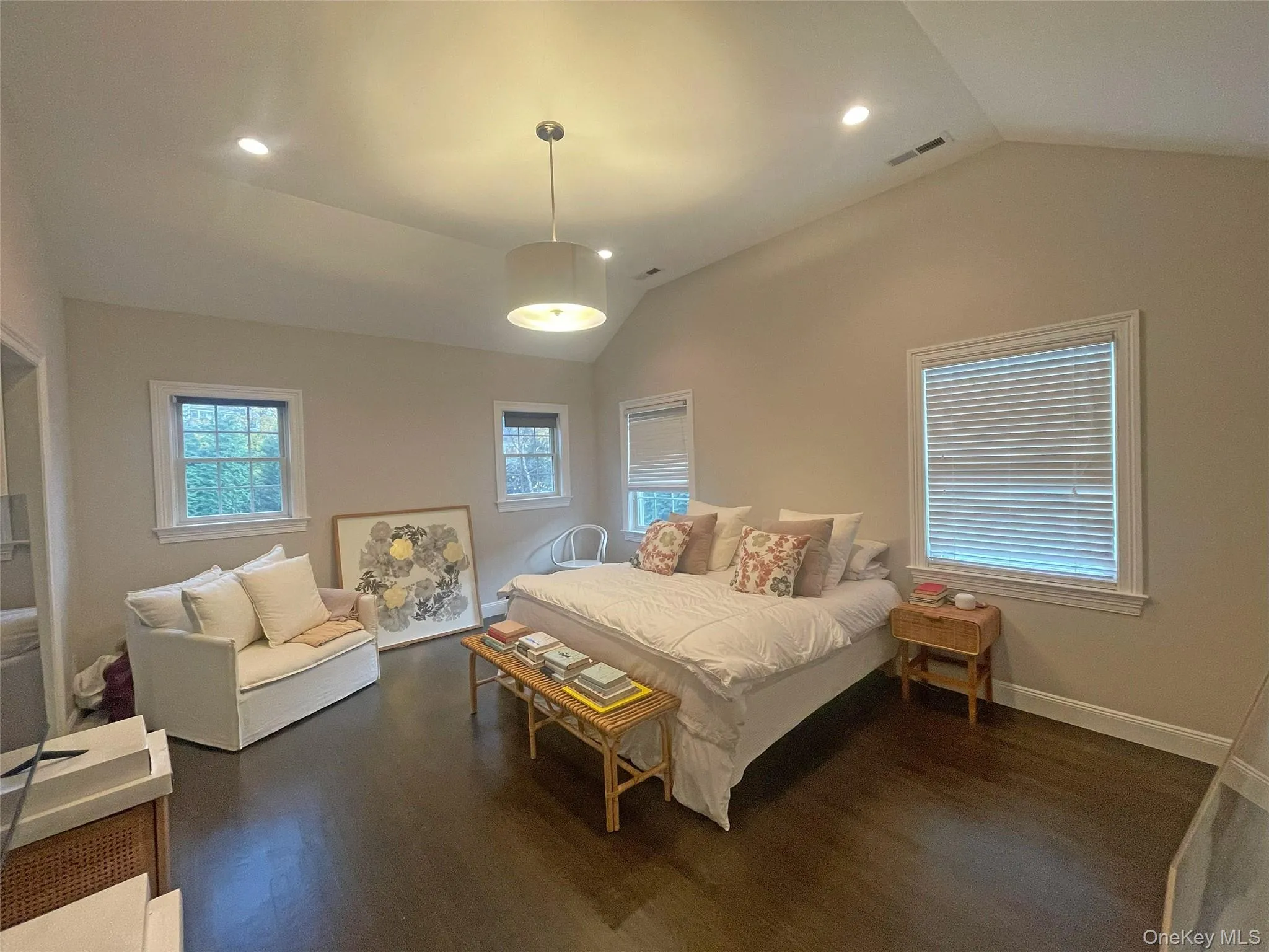 Bedroom with vaulted ceiling, dark wood finished floors, and recessed lighting Bedroom with vaulted ceiling, dark wood finished floors, and recessed lighting