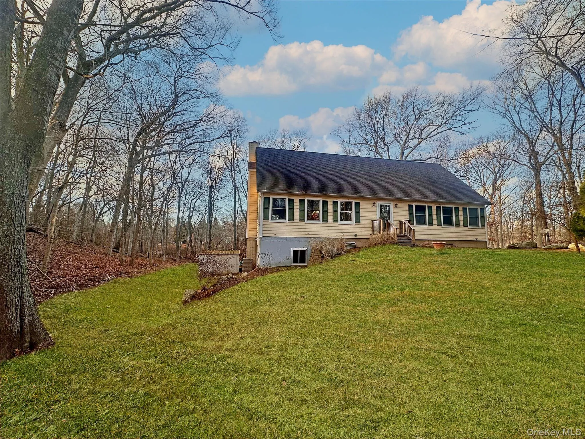 View of front facade with a front lawn and a chimney View of front facade with a front lawn and a chimney