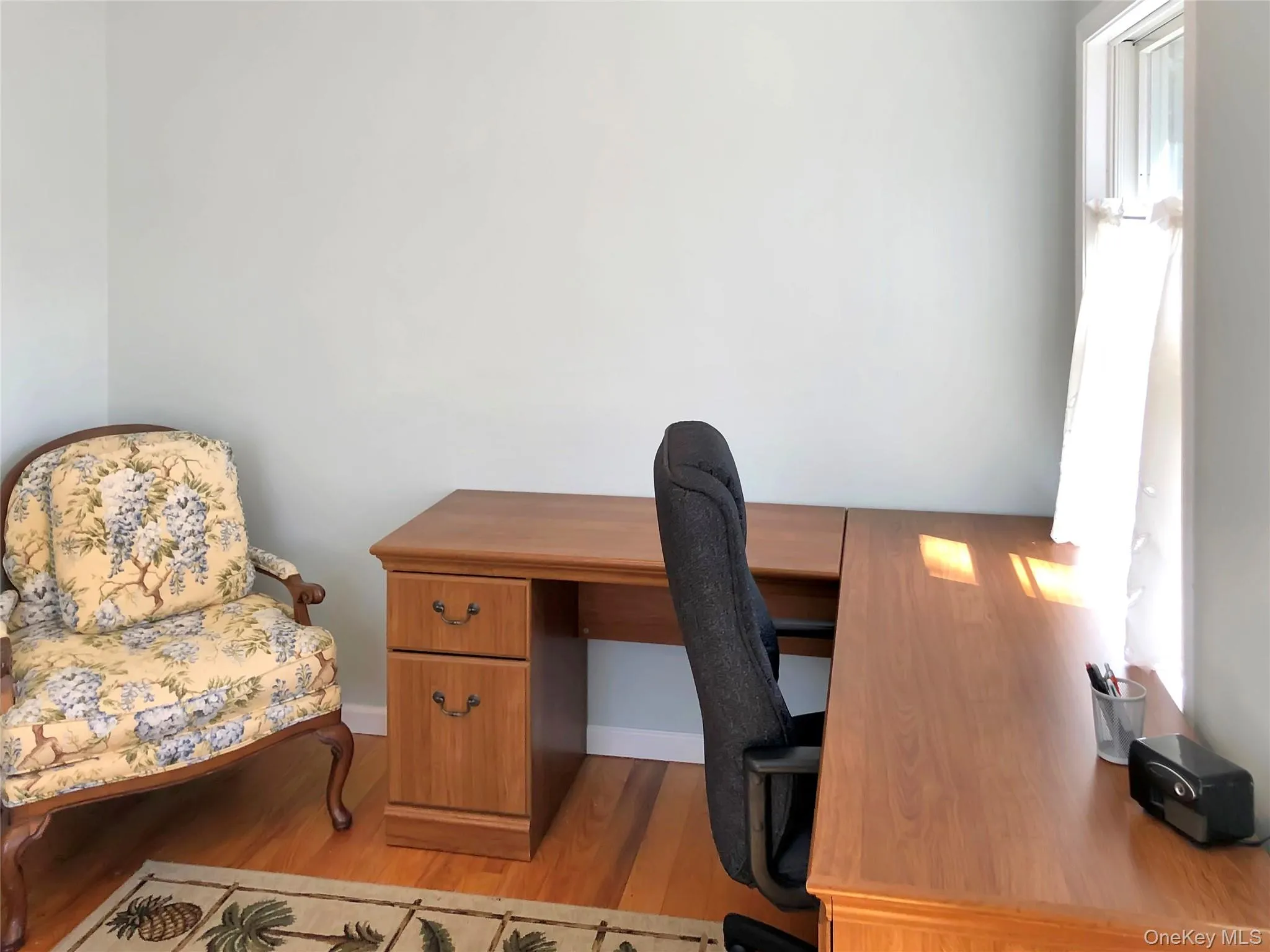 Office with light wood finished floors and baseboards Office with light wood finished floors and baseboards