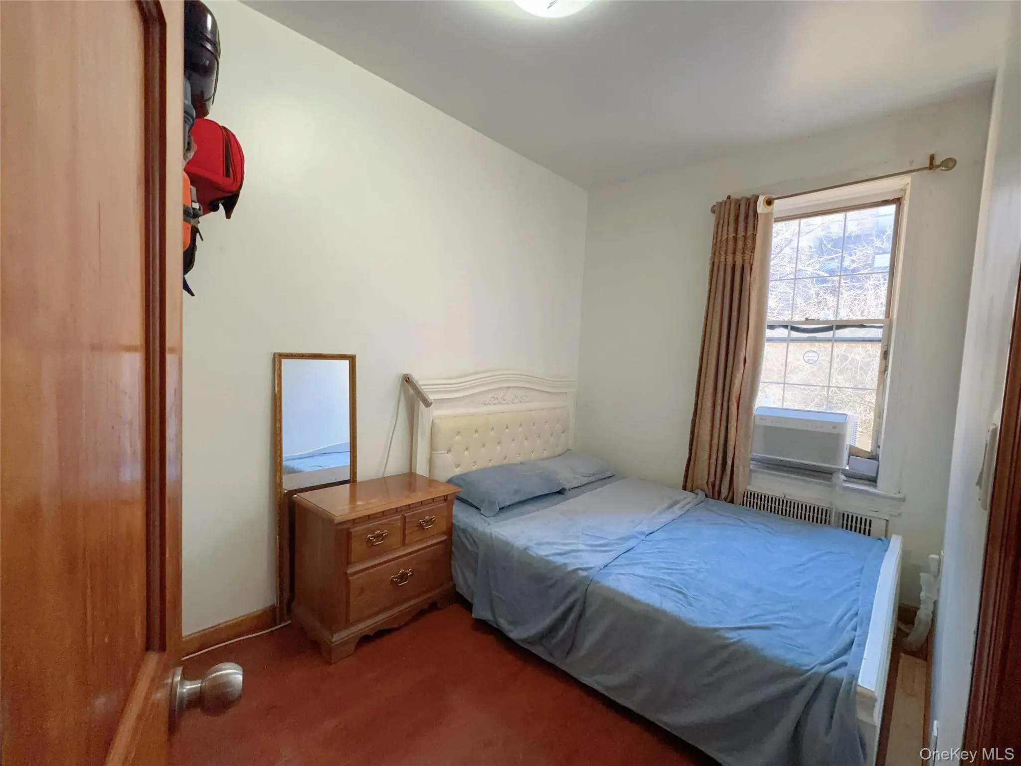 Carpeted bedroom featuring radiator heating unit Carpeted bedroom featuring radiator heating unit