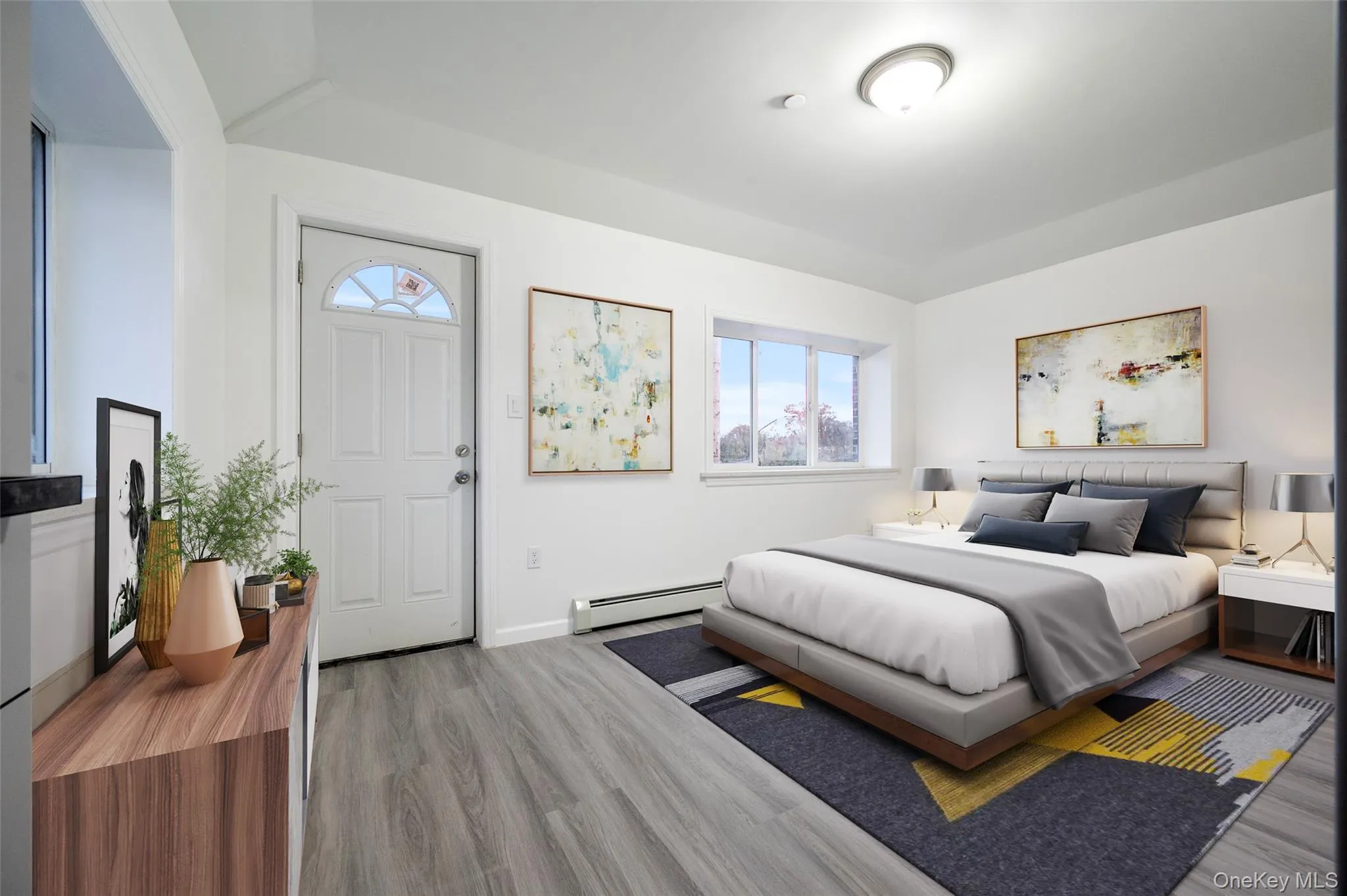 Bedroom featuring a baseboard heating unit and wood finished floors Bedroom featuring a baseboard heating unit and wood finished floors