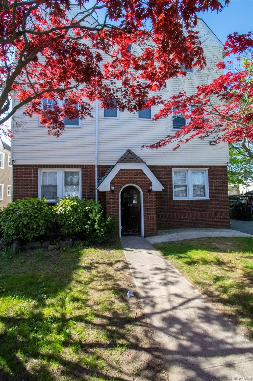 View of front of house with brick siding and a front yard View of front of house with brick siding and a front yard