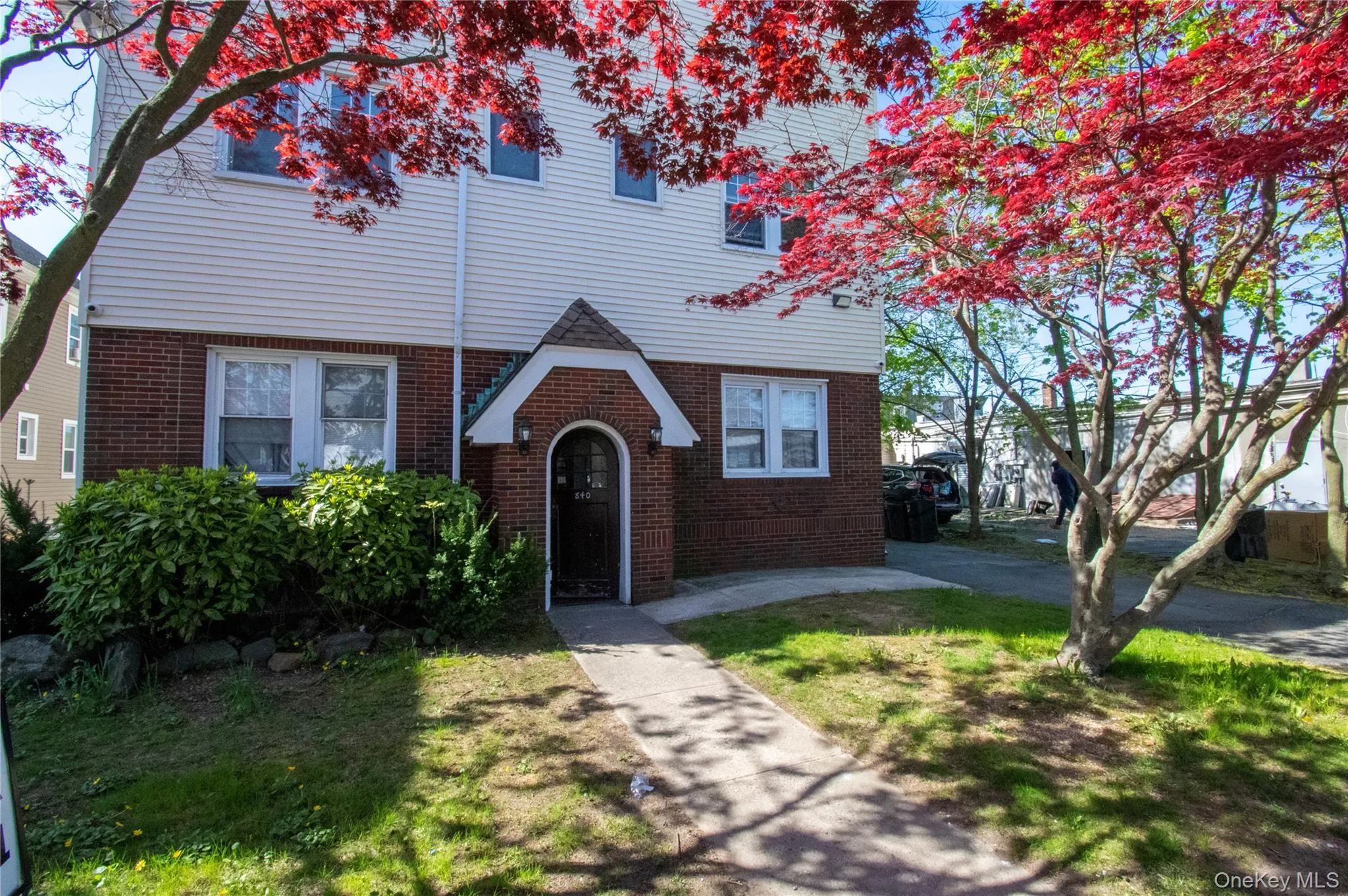 View of front of home with brick siding and a front yard View of front of home with brick siding and a front yard