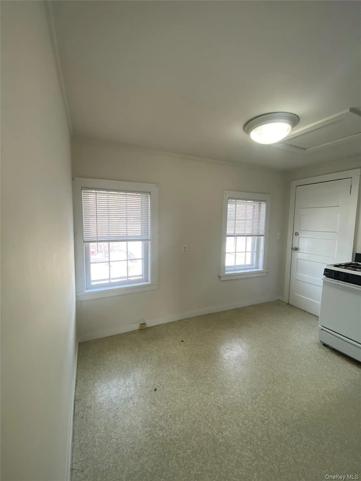 Empty room with baseboards and light floors Empty room with baseboards and light floors