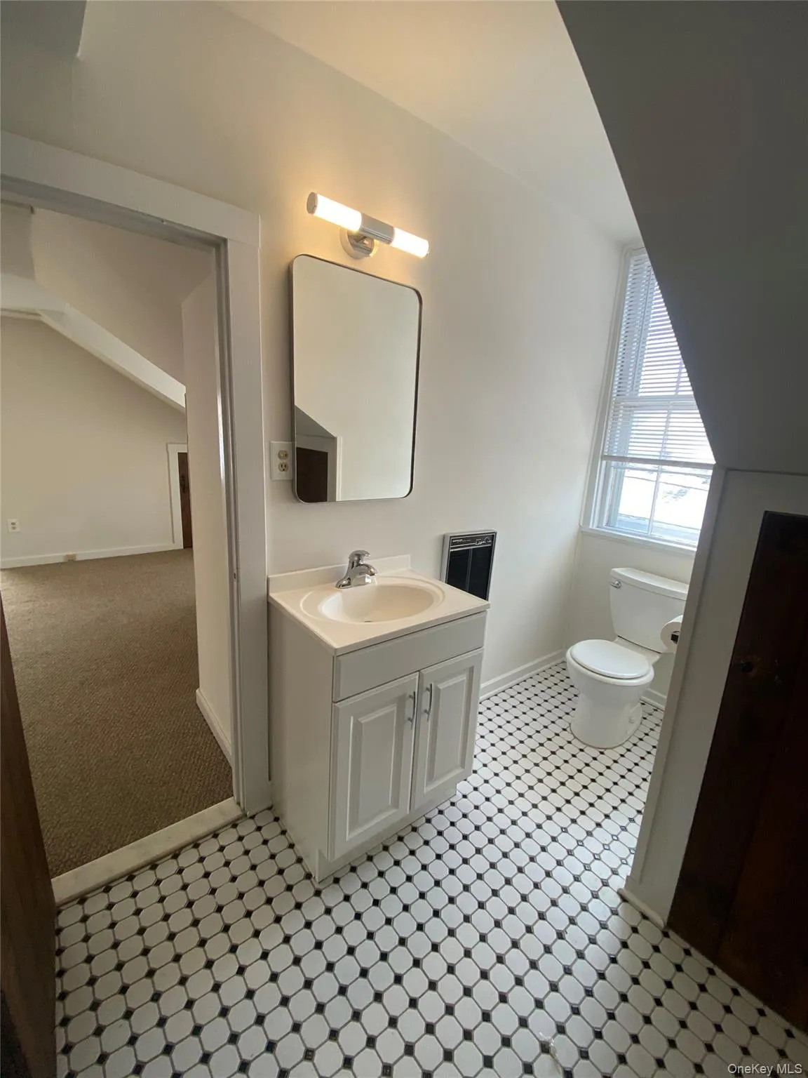 Bathroom featuring vanity, light colored carpet, and light flooring Bathroom featuring vanity, light colored carpet, and light flooring