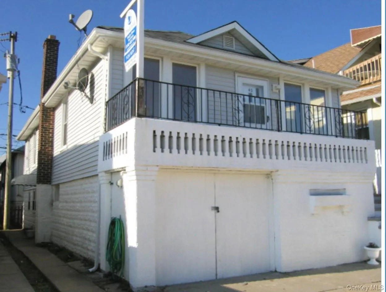 View of front of house featuring a balcony and a chimney View of front of house featuring a balcony and a chimney