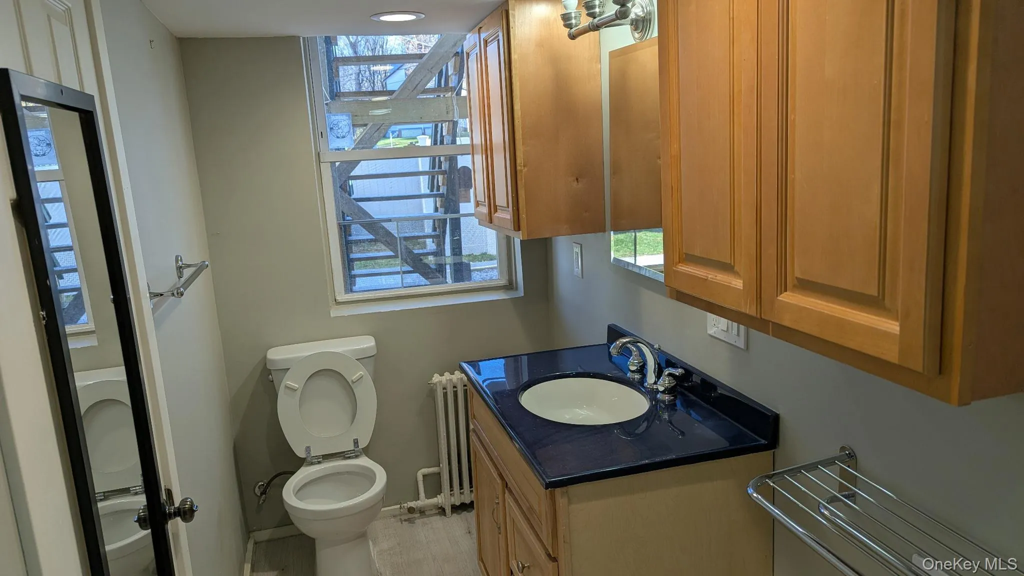 Half bath with vanity and radiator heating unit Half bath with vanity and radiator heating unit