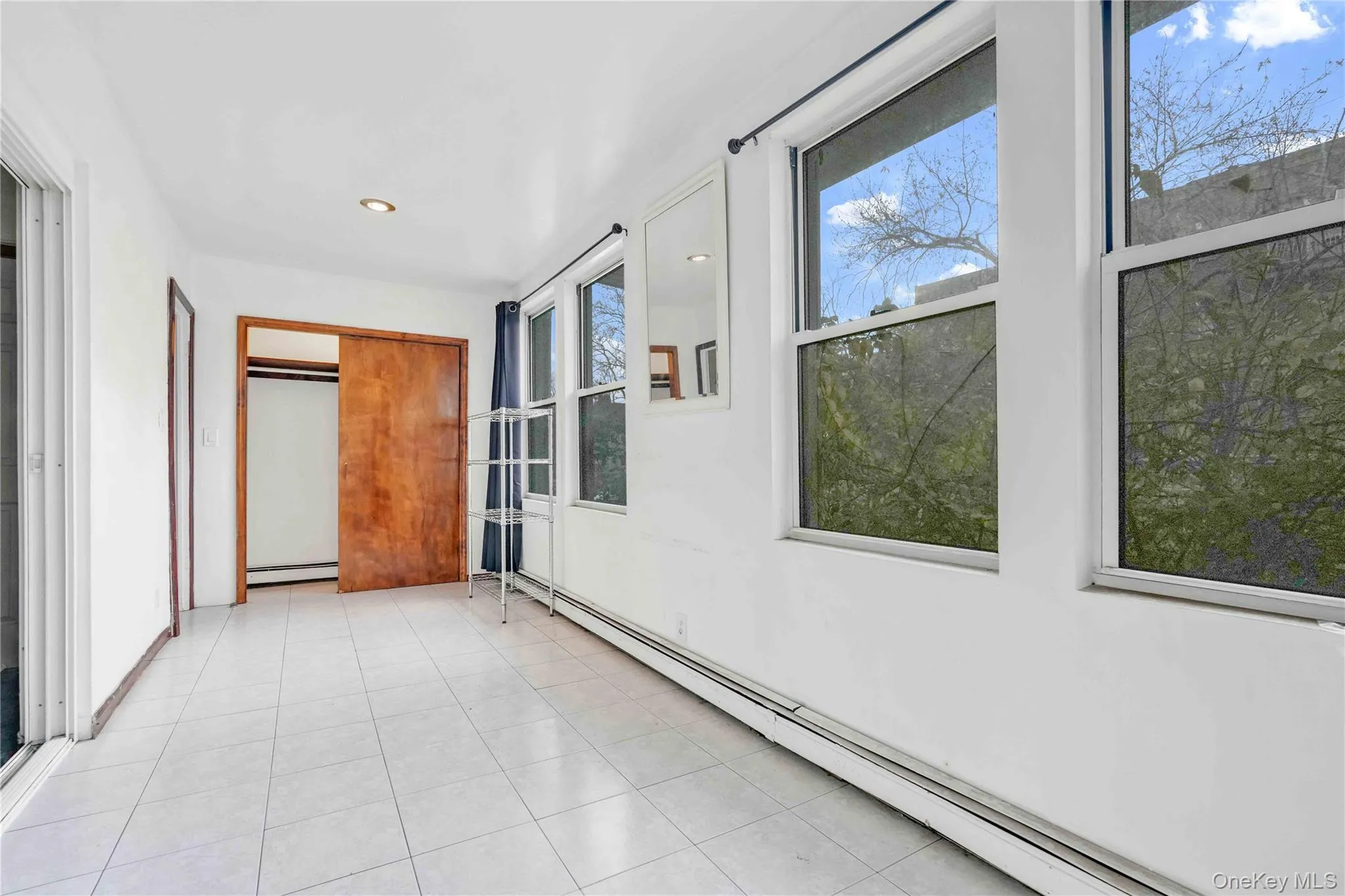 Unfurnished sunroom with a baseboard radiator Unfurnished sunroom with a baseboard radiator