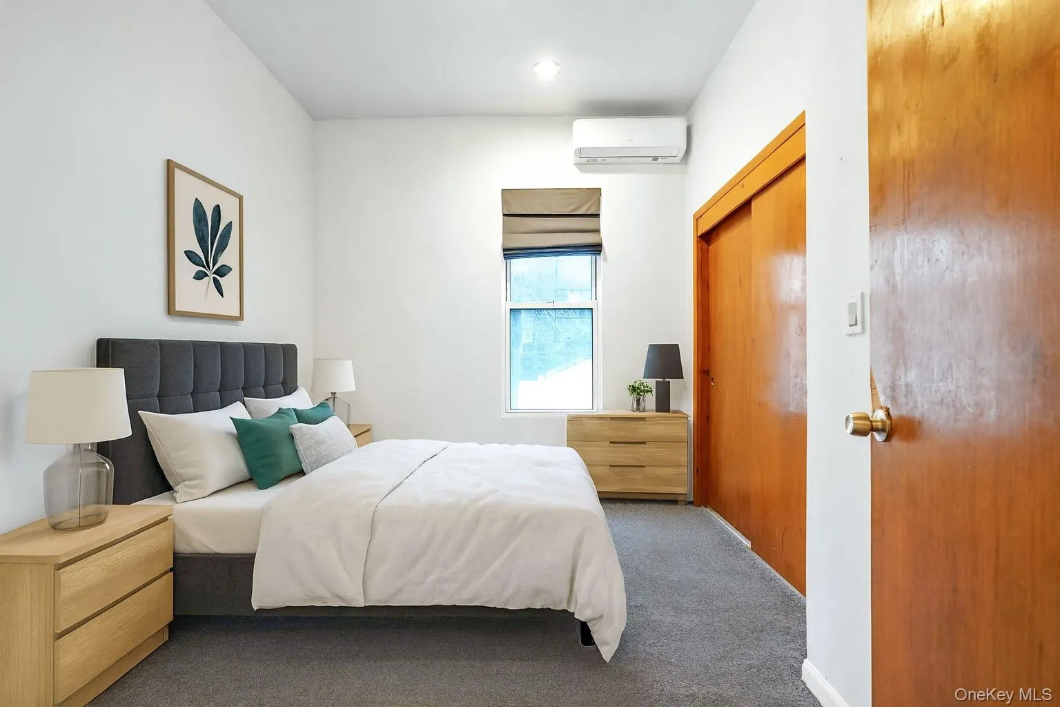 Carpeted bedroom featuring a wall unit AC and baseboards Carpeted bedroom featuring a wall unit AC and baseboards