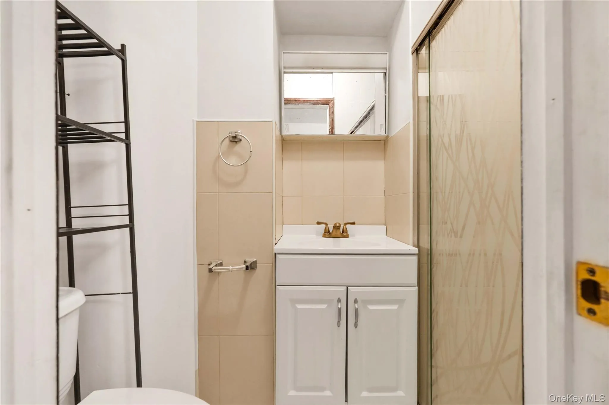 Full bath with vanity, tile walls, and a stall shower Full bath with vanity, tile walls, and a stall shower