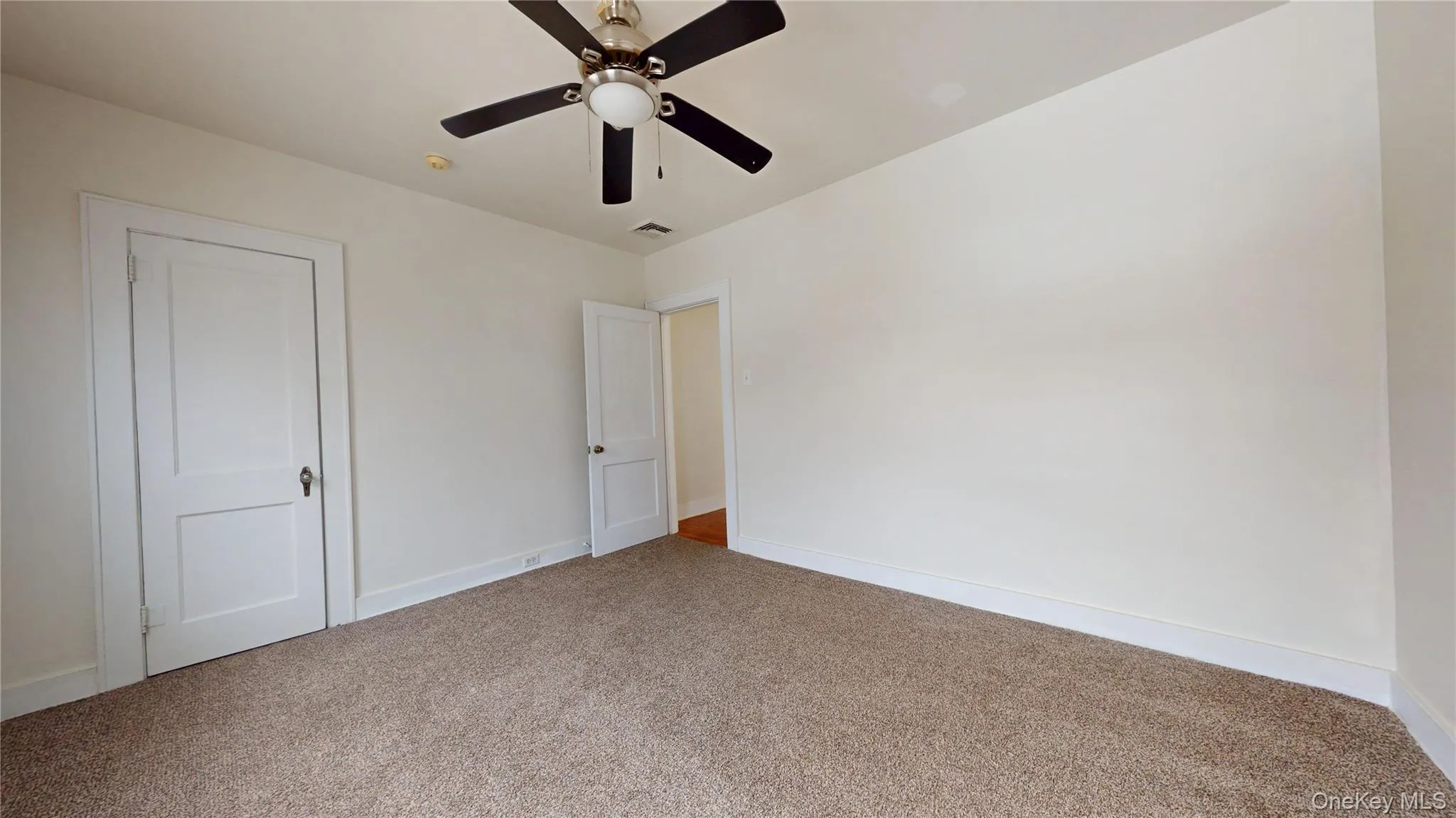 Unfurnished bedroom with carpet floors and a ceiling fan Unfurnished bedroom with carpet floors and a ceiling fan