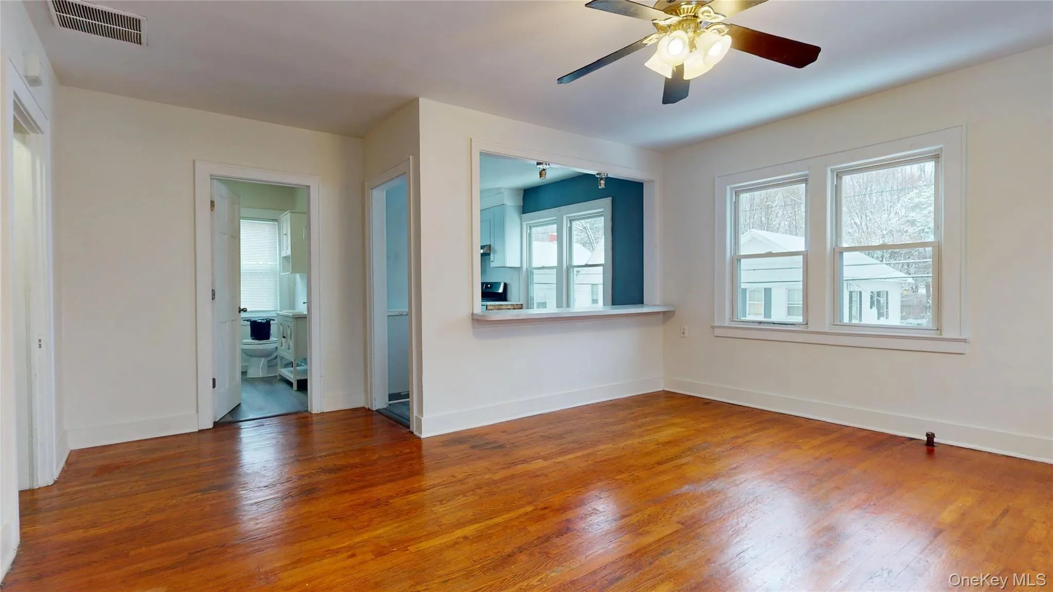Empty room featuring wood finished floors and ceiling fan Empty room featuring wood finished floors and ceiling fan