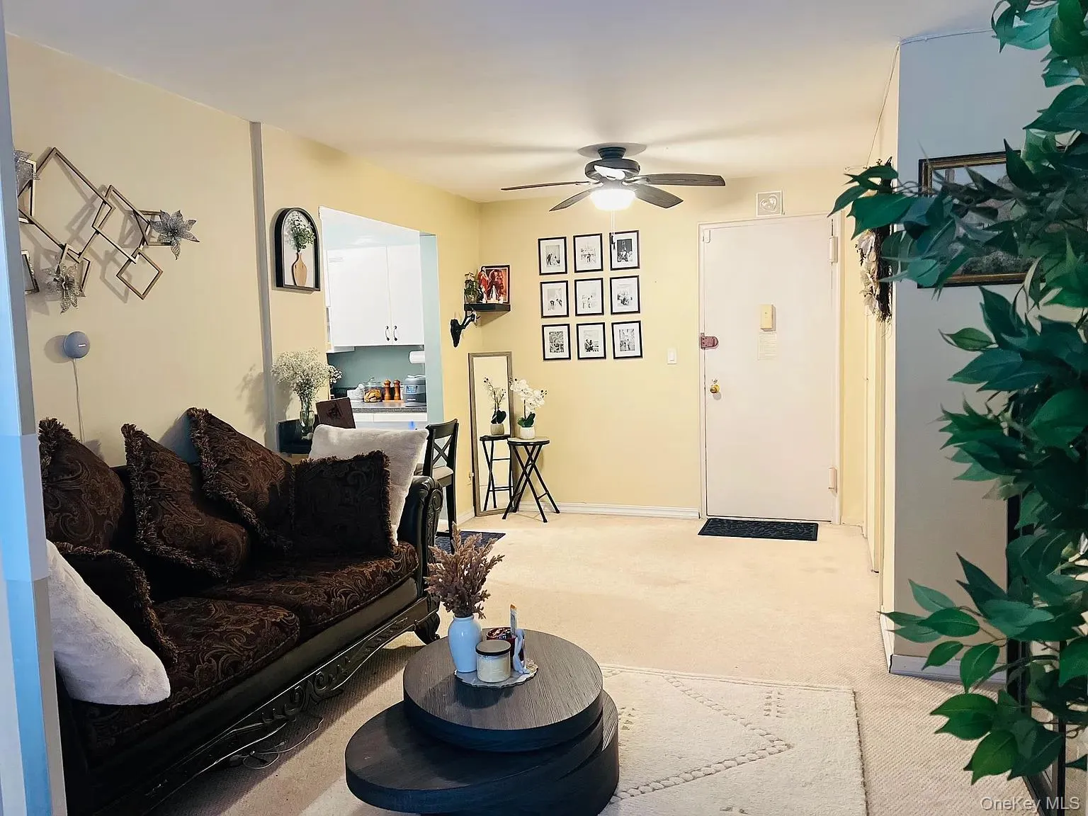 Living area featuring a ceiling fan and light carpet Living area featuring a ceiling fan and light carpet