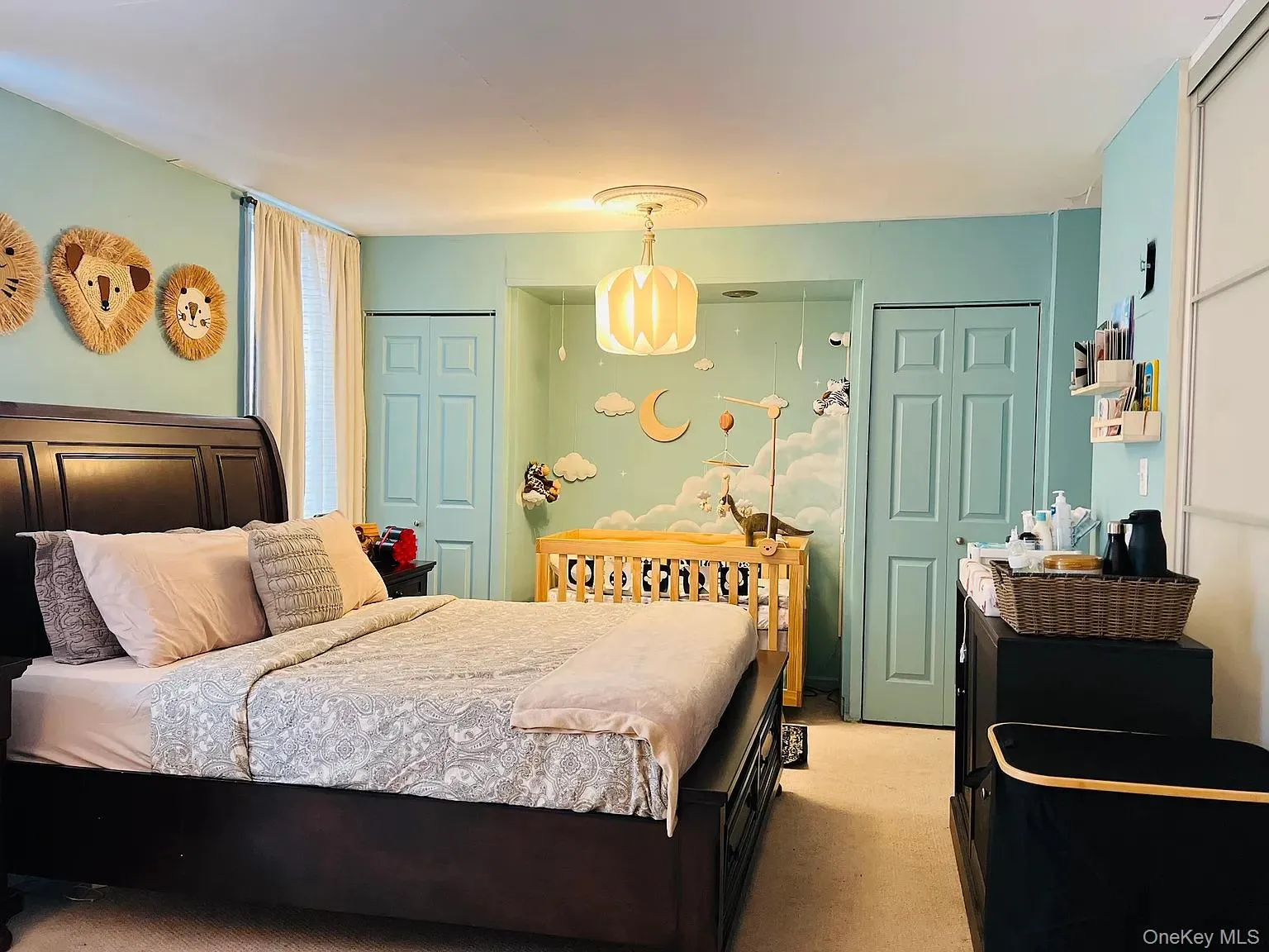 Bedroom featuring light colored carpet and multiple closets Bedroom featuring light colored carpet and multiple closets