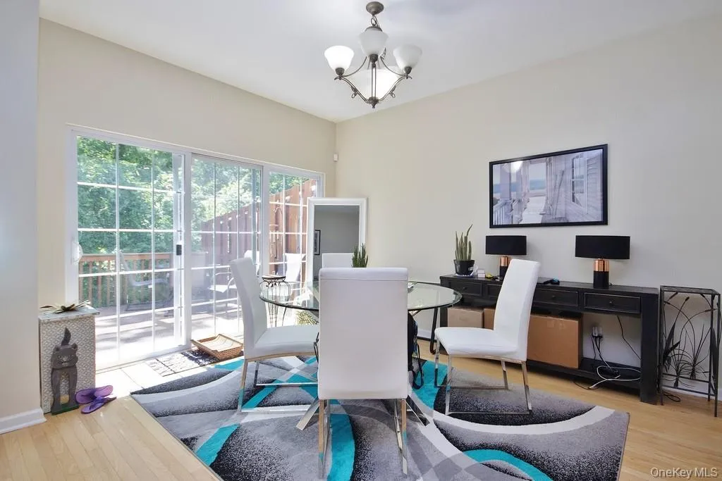 Dining area with sliders to deck and wooded rear yard Dining area with sliders to deck and wooded rear yard