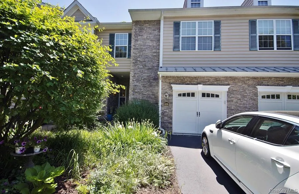 Front door privately set back to left of one car garage. Front door privately set back to left of one car garage.