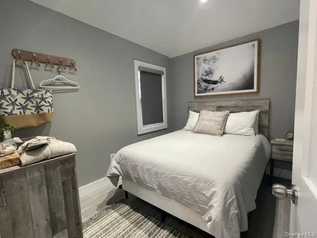 Bedroom featuring baseboards and light wood-style flooring Bedroom featuring baseboards and light wood-style flooring