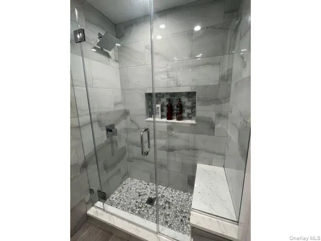 Bathroom featuring a stall shower Bathroom featuring a stall shower