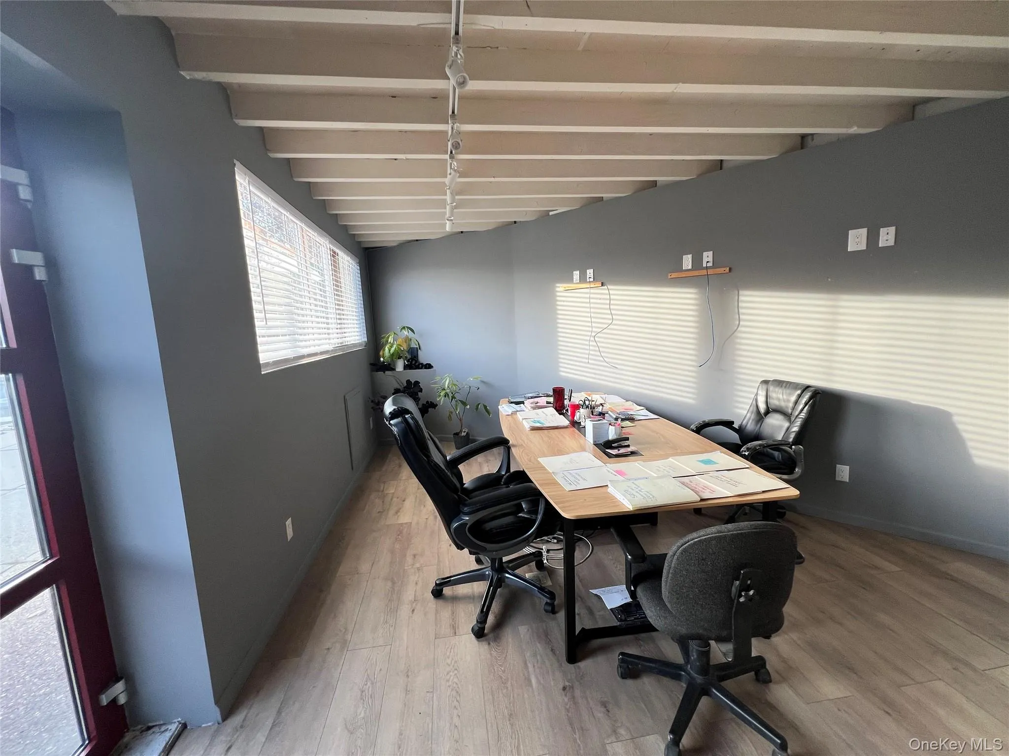 Office featuring beam ceiling and light wood-style floors Office featuring beam ceiling and light wood-style floors