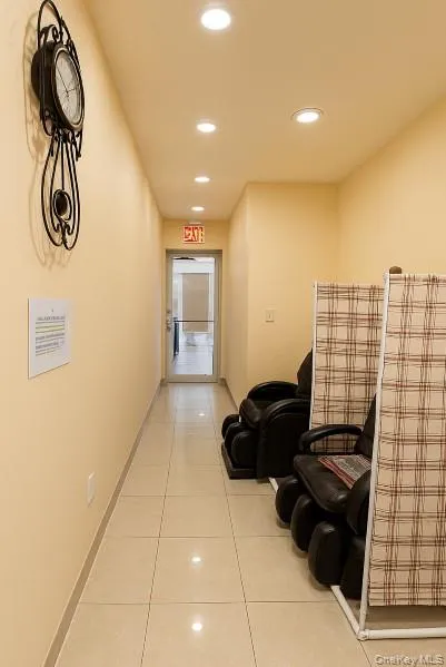 Hall featuring recessed lighting and light tile patterned floors Hall featuring recessed lighting and light tile patterned floors