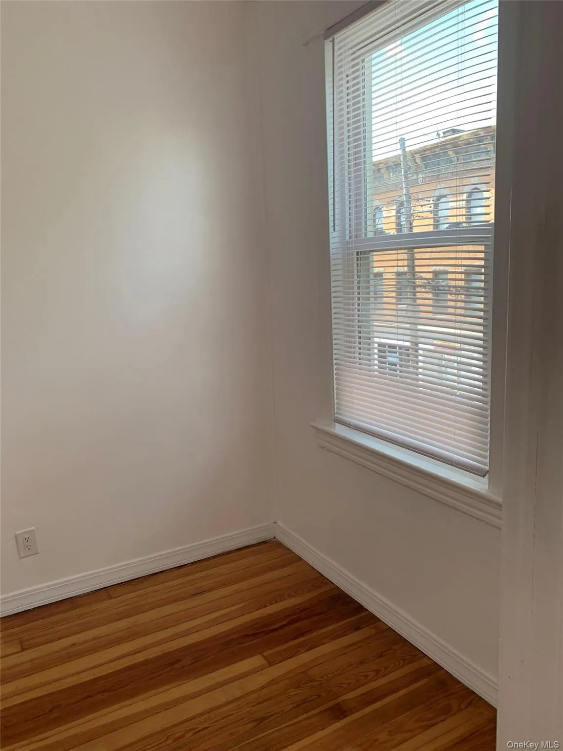 Spare room with baseboards and light wood-style floors Spare room with baseboards and light wood-style floors