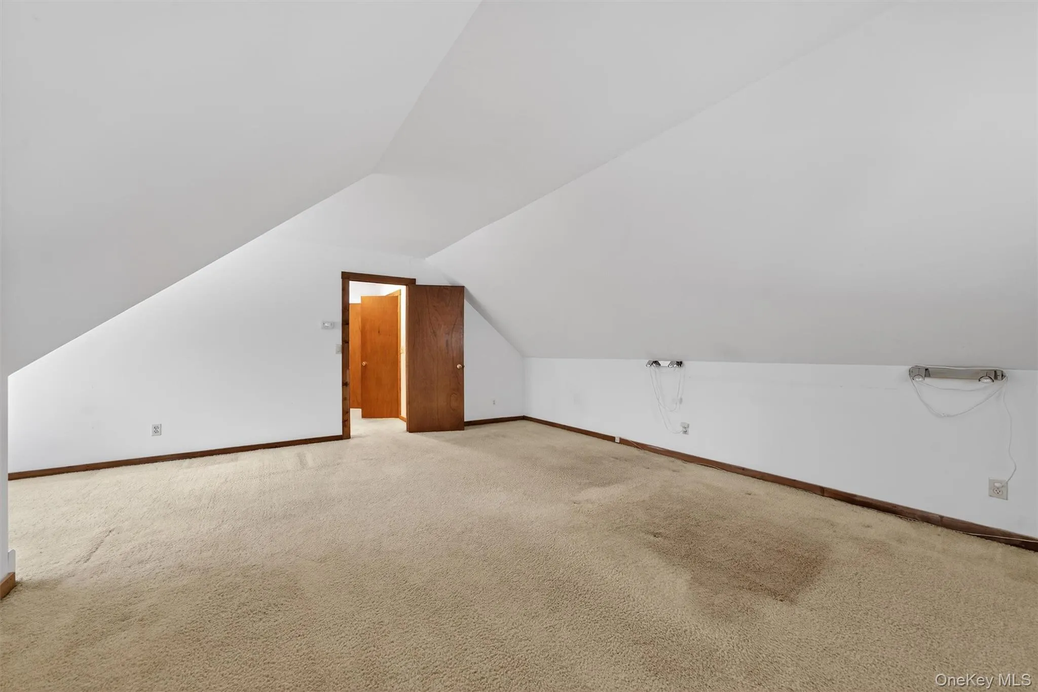 Bonus room with vaulted ceiling and carpet floors Bonus room with vaulted ceiling and carpet floors