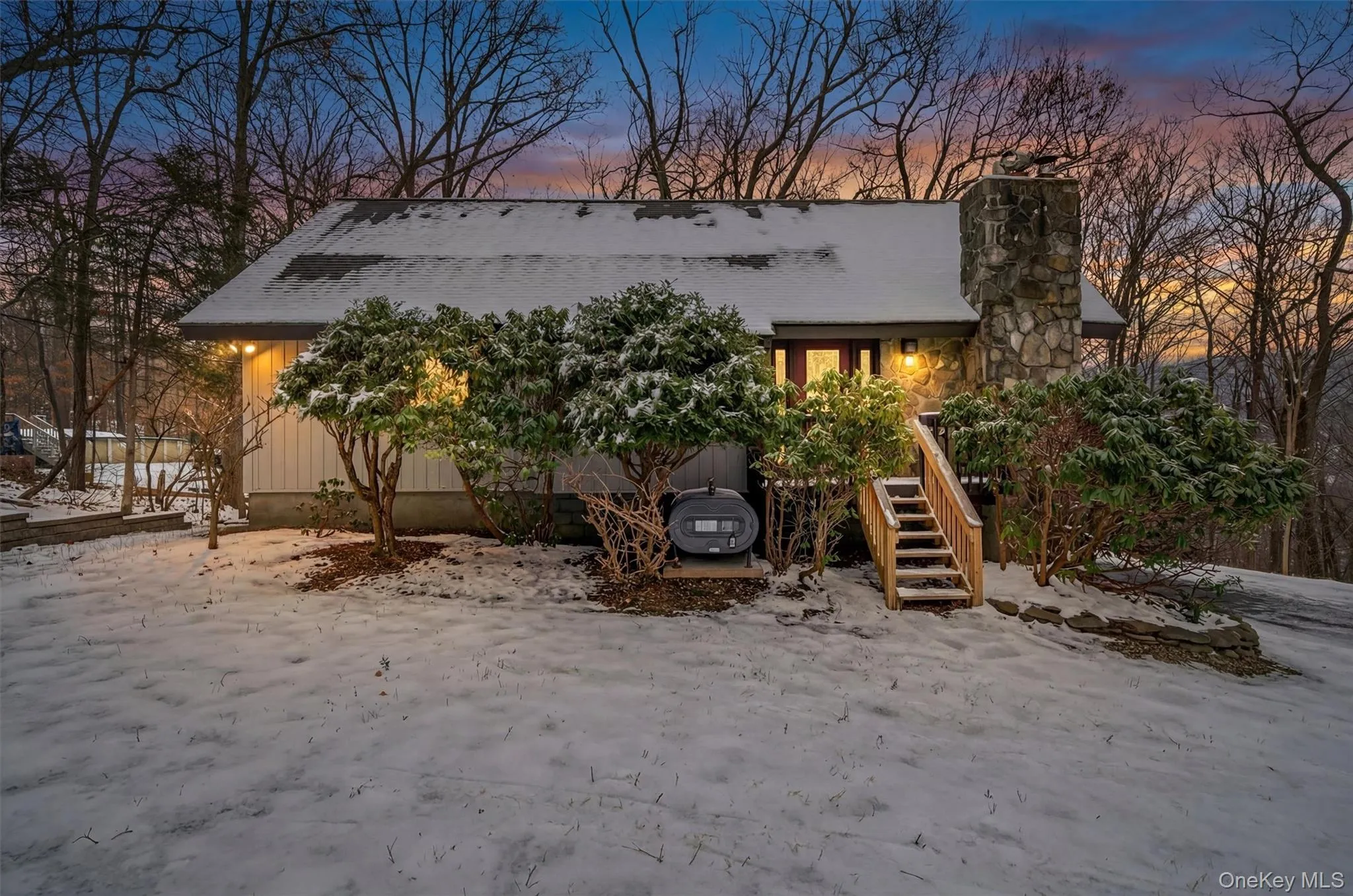 View of front of property featuring a chimney and stairway View of front of property featuring a chimney and stairway