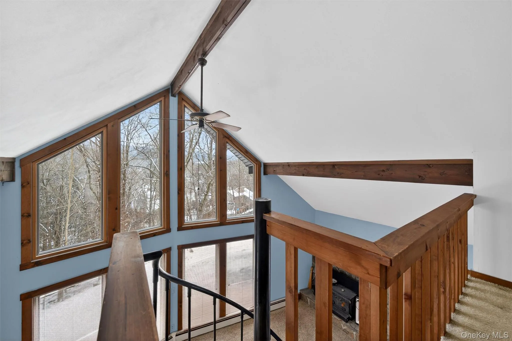 Detailed view of beam ceiling, carpet flooring, and a ceiling fan Detailed view of beam ceiling, carpet flooring, and a ceiling fan