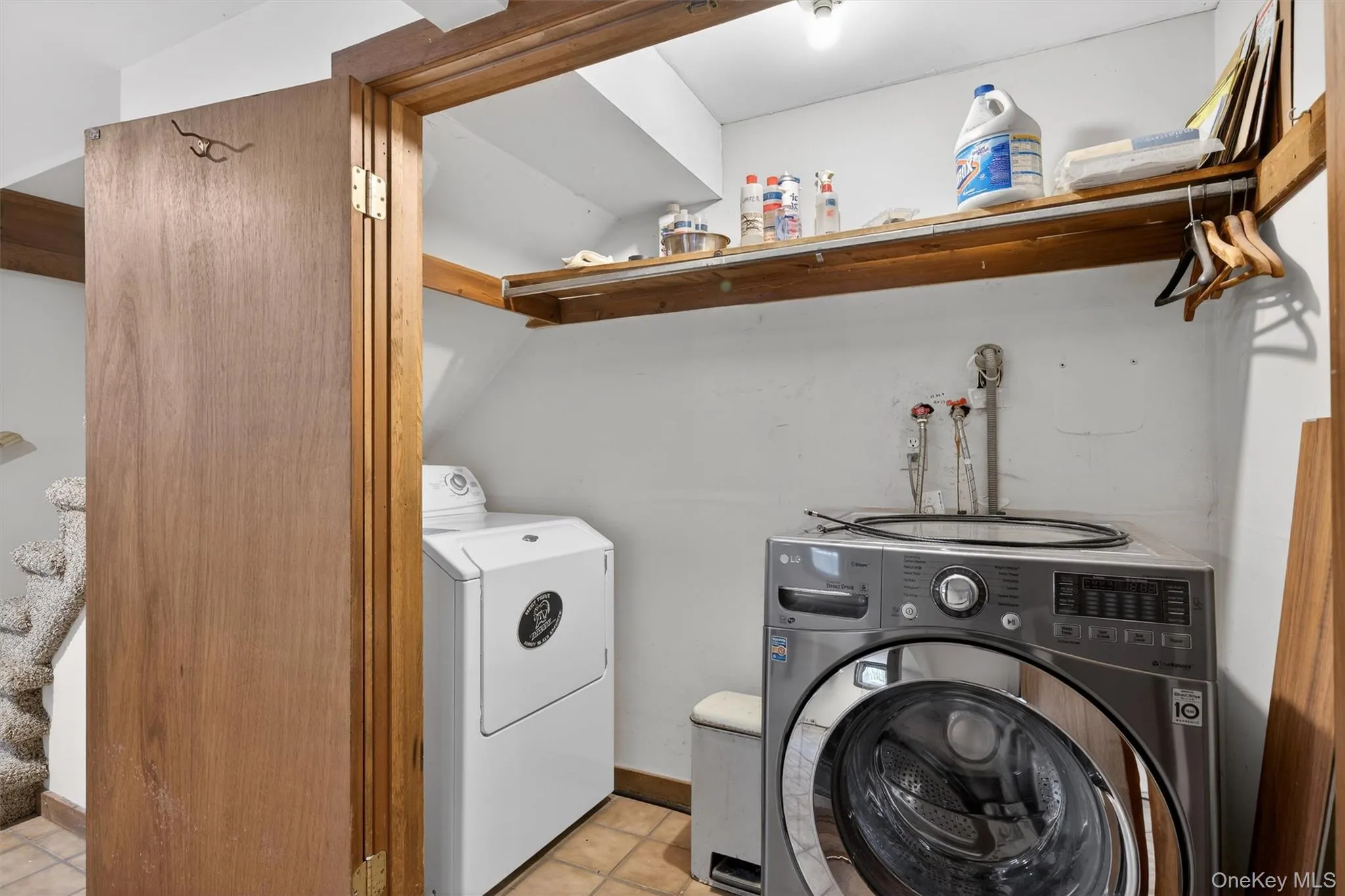 Laundry room featuring washer and clothes dryer and tile patterned floors Laundry room featuring washer and clothes dryer and tile patterned floors