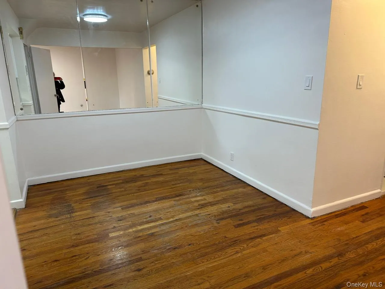 Unfurnished room with dark wood finished floors Unfurnished room with dark wood finished floors